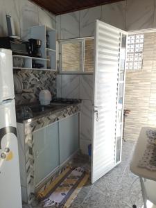 a kitchen being remodeled with an open door at Kitnet Apto Aconchegante na praia do forte in Cabo Frio