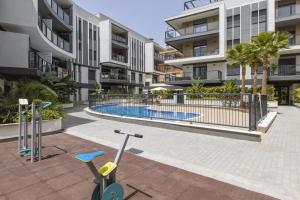 an apartment complex with a swimming pool in a courtyard at Essential by Charlie in Jávea