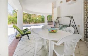 a white dining room with a white table and chairs at Charming Villa in Monreale with Private Pool in Pioppo