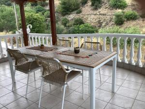 a white table and chairs on a porch at Sunny Luxury House Iraklitsa in Iraklitsa