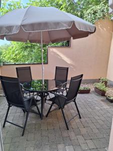 a table and chairs with an umbrella on a patio at Apartman Luka in Pula +3 photos