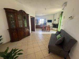 a living room with a couch and a kitchen at Casa il sorbo in Tarquinia