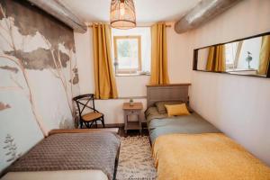 a small bedroom with two beds and a window at Gîte du Bief in Pluvigner +12 photos