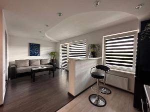 a living room with a couch and a bar stool at Valmiera in Valmiera