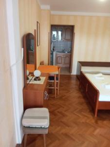 a room with a bed and a table and a mirror at Studio Danica in Banjol