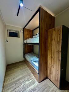 a large wooden bunk bed in a room at Wood hostel Osh in Osh +12 photos