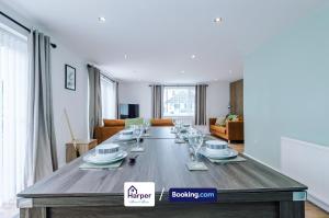a large wooden table in a living room at Sleeps 8 Loft bedroom By Harperletting Short Lets & Serviced Accommodation Buckley With Pool table & Long or Short stays in Hawarden