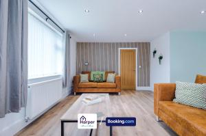 a living room with a couch and a chair at Sleeps 8 Loft bedroom By Harperletting Short Lets & Serviced Accommodation Buckley With Pool table & Long or Short stays in Hawarden