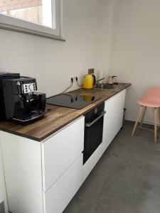 a kitchen with a counter top and a stove top oven at Königlicher Aufenthalt inmitten der Natur in Hürth