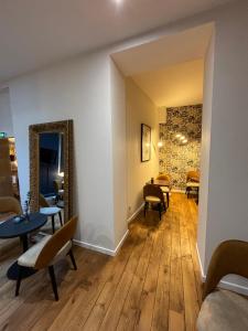 a waiting room with chairs and a mirror at Hotel Le Jacquemart in Dijon