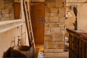 a bathroom with a shower with wooden walls at YAY Sustainable in Guachaca