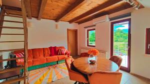 a living room with a couch and a table at Soča Home Bovec in Bovec