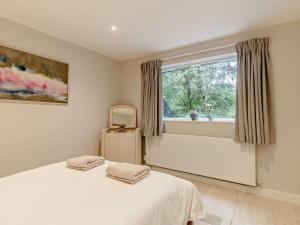 a bedroom with a white bed and a window at 3 bed in Beaulieu 47431 in Beaulieu