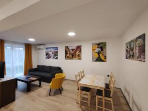 a living room with a table and a couch at Sweet house in Novi Sad +13 photos