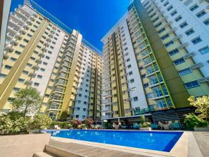 a view of three apartment buildings with a swimming pool at Mesaverte Residences Cozy Studio Unit in Cagayan de Oro +8 photos