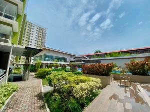 a courtyard of a building with chairs and plants at Mesaverte Residences Cozy Studio Unit in Cagayan de Oro