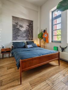 a bedroom with a large bed with a blue blanket at Thisseion Lofts George in Athens +25 photos