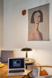a laptop computer sitting on top of a wooden table at Thisseion Lofts George in Athens