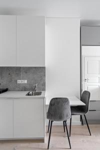 cocina con fregadero, mesa y silla en Central Cozy 1Bedroom Apartment with Sofa Bed - Sleeps 4, en Vilna