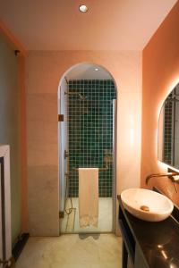 a bathroom with a shower and a sink and a mirror at Bur'Dera - a Boutique Luxury Hotel in Jaipur