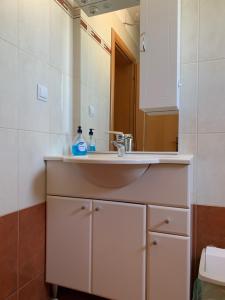 a bathroom with a sink and a mirror at Apartments Milan in Peroj +26 photos