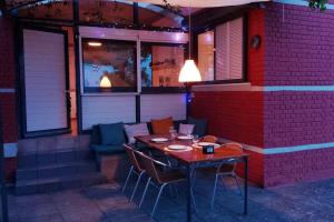 a table and chairs on the side of a building at Εξοχικό σπίτι σε κτήμα δίπλα στη θάλασσα in Mantamádos +69 photos