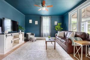 a living room with a couch and a ceiling fan at The Farm House in Dillsburg