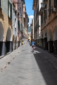 a person riding a bike down a street at Gauli casa vacanze in Chiavari