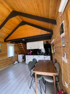a kitchen and dining room with a table and chairs at 101 Gün Kiralık Havuzlu Lake House kayacık in Dalaman