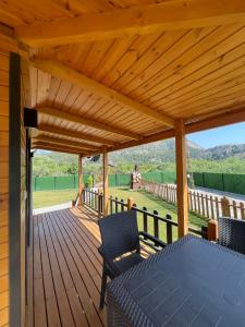 a wooden deck with a table and chairs on it at 101 Gün Kiralık Havuzlu Lake House kayacık in Dalaman +24 photos