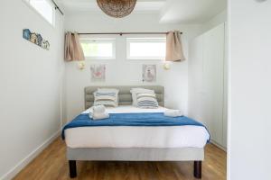 een slaapkamer met een bed met blauwe en witte lakens bij Maison de rêve proche métro et RER in Alfortville