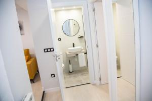un bagno con lavandino e specchio di Pregonero Urban Suites - Amarillo a Soria Altre 15 foto