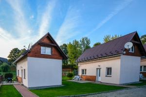 a house with a brown roof and a white garage at Privát u Raka in Liptovský Trnovec