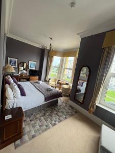 a bedroom with a large bed and a large mirror at 17 Wilmington Square in Eastbourne