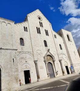 a large stone building with a clock tower at La Cas d Zii la Giulia in Bari