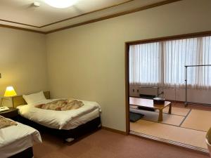 Postel nebo postele na pokoji v ubytování Asakusa Sanso + 37 fotografií
