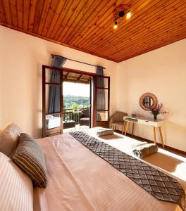 a bedroom with a large bed and a window at Golden View Apartments in Arillas