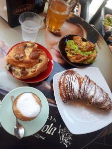 a table with two plates of breakfast foods and a drink at Porta sul Mare in Tropea