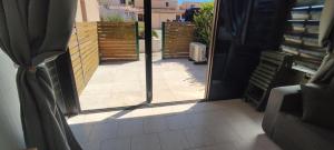 an open door with a view of a patio at AIGUES-MORTES - AGRÉABLE T.2 - (+ de 40m² ) in Aigues-Mortes