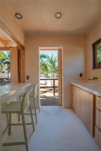 a kitchen with a table and chairs and a view of the ocean at Mangle Rojo Palafitos in La Manzanilla