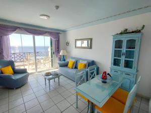 a living room with a couch and a table at Rocas del Mar 408 in Costa Del Silencio