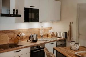 a kitchen with a sink and a counter top at Gîte de la Rivière in Pluvigner