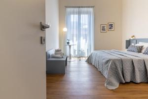 Postel nebo postele na pokoji v ubytování Oldoini Luxury Apartment and Suites