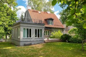a small house with a red roof at Villa Ernesaks - Private yard and grill in Tallinn +38 photos