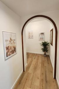 an arched hallway with paintings and a potted plant at CLASSY HOMES - A due passi dal mare in Sanremo