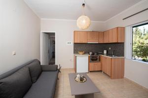 a living room with a couch and a kitchen at Agnantio in Agios Nikitas +37 photos