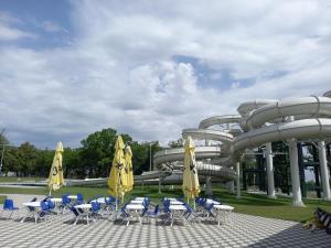 a water park with a water slide with chairs and umbrellas at Vila Madams - Palić-Serbia in Palić