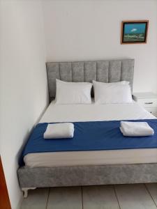 a large bed with two pillows on top of it at Baci Apartments in Ksamil