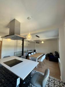 a kitchen and living room with a table and chairs at A de Carmiña in A Coruña