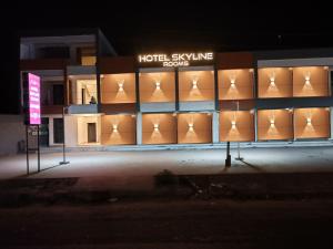 a building with a hotel style line of windows at night at Hotel Skyline in Dholka
